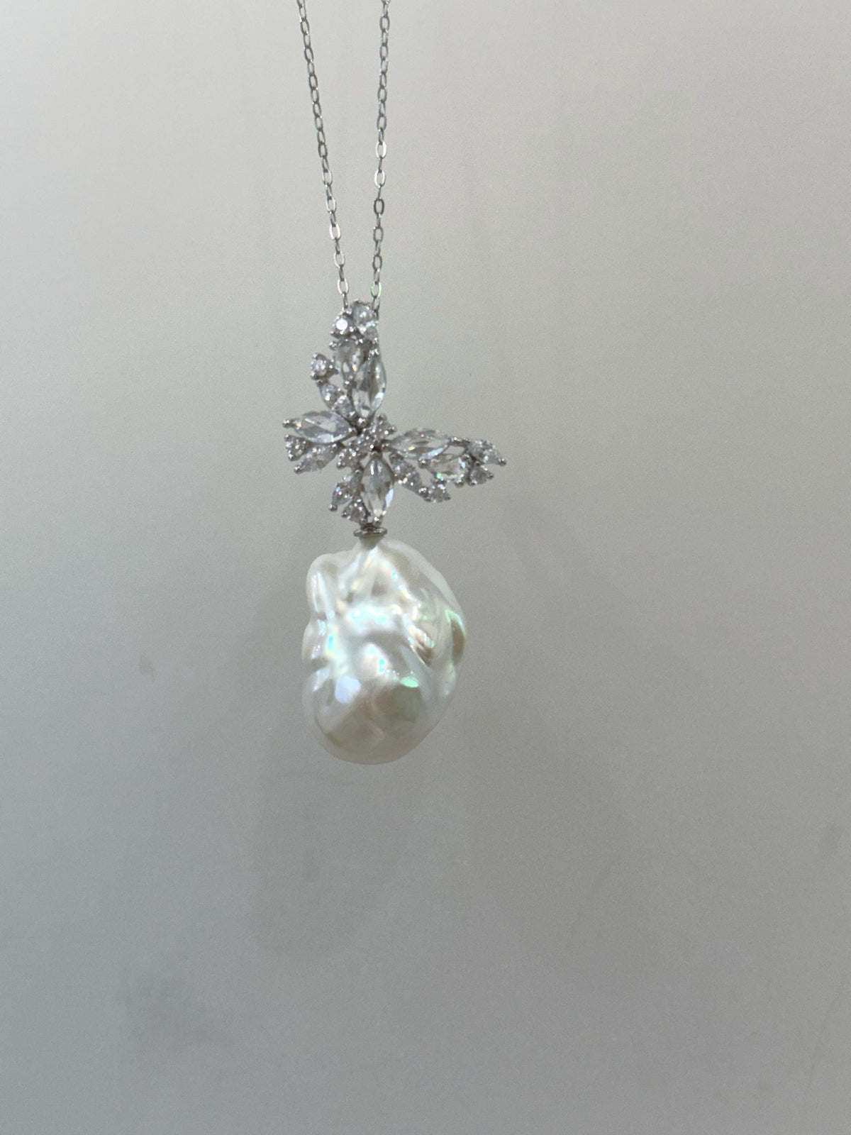 Close-up of a luminous white baroque pearl with colorful overtones