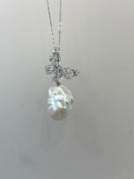 Close-up of a luminous white baroque pearl with colorful overtones