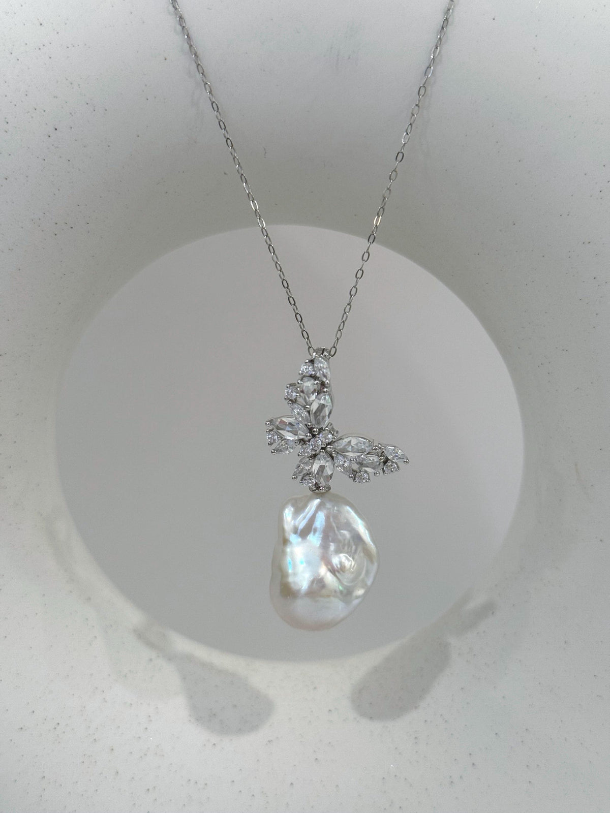 White iridescent baroque pearl necklace on a delicate silver chain
