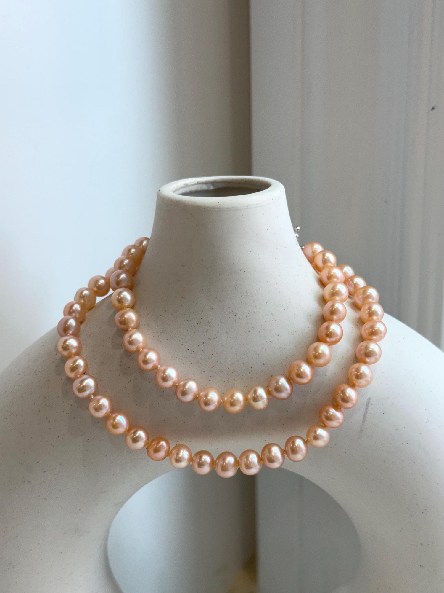 Peach Pearls Necklace: Extreme luster Mirrored effect, 6.2-6.7mm, S925 silver clips, knotted 17.8”long. No tariffs