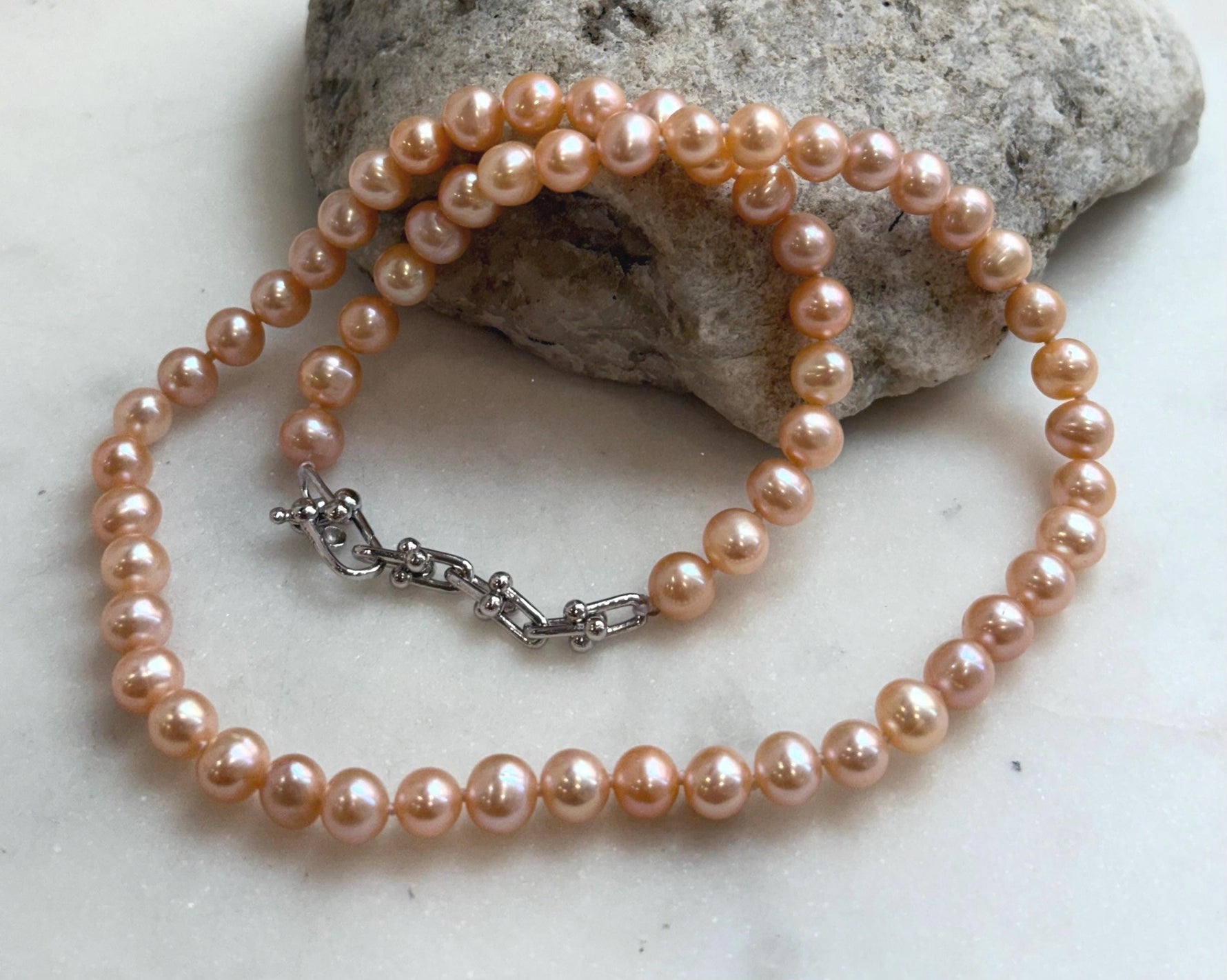 Peach Pearls Necklace: Extreme luster Mirrored effect, 6.2-6.7mm, S925 silver clips, knotted 17.8”long. No tariffs for her daily wear