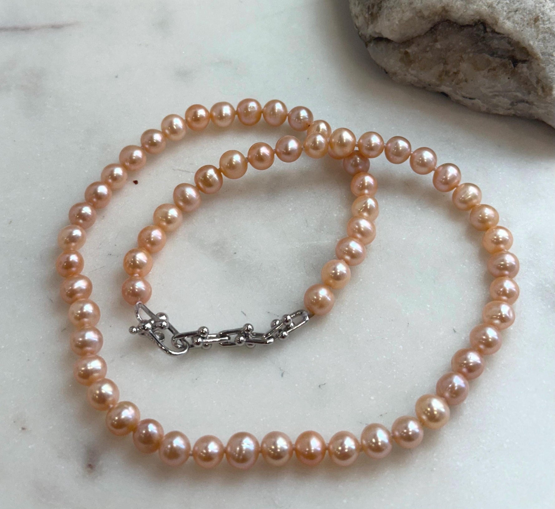 Peach Pearls Necklace: Extreme luster Mirrored effect, 6.2-6.7mm, S925 silver clips, knotted 17.8”long. No tariffs