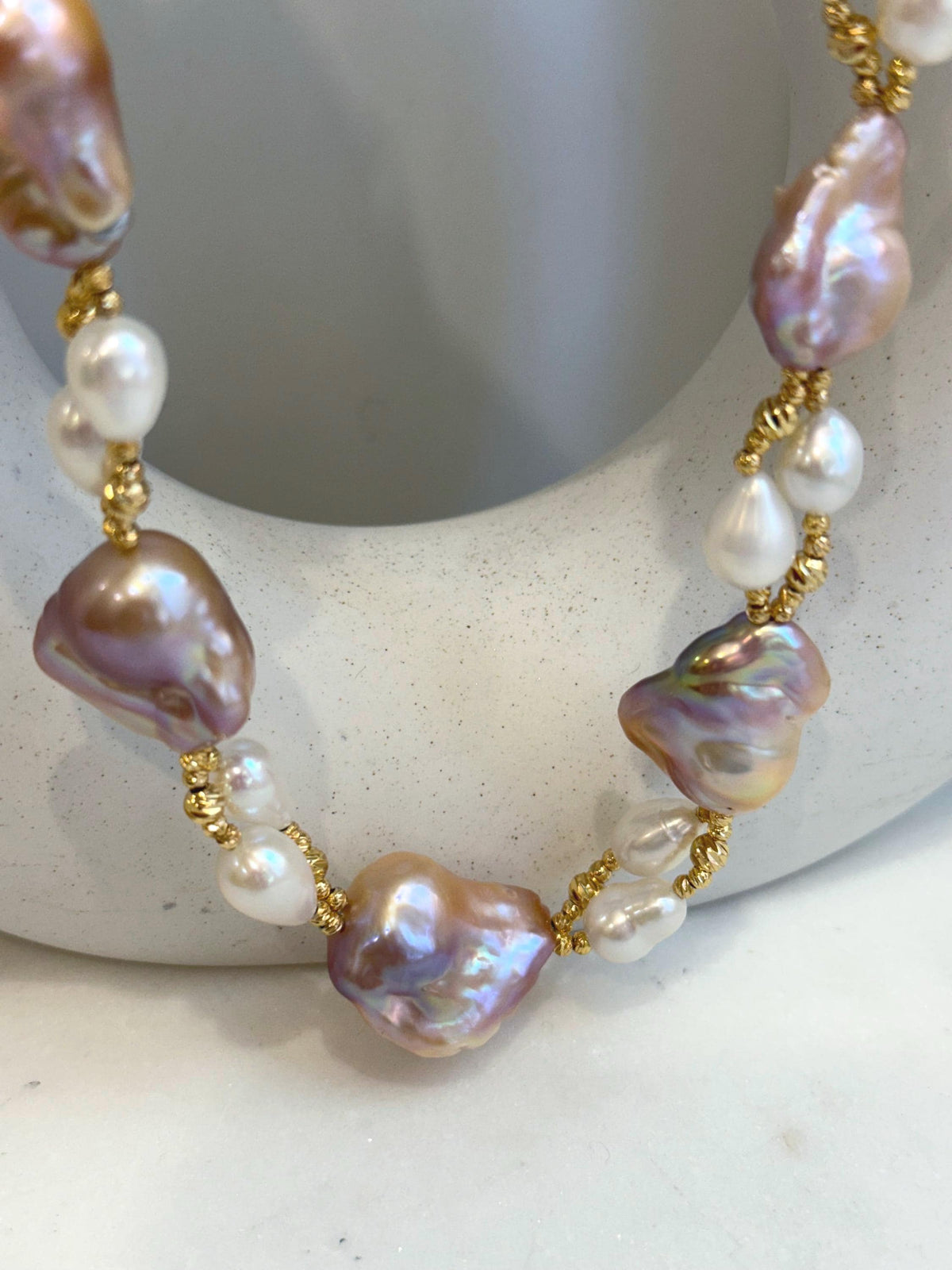 Baroque Rice Keshi Pearls Designed Necklace: 9pcs Extreme luster, peach rose iridescent, to 24mm, 18.3”