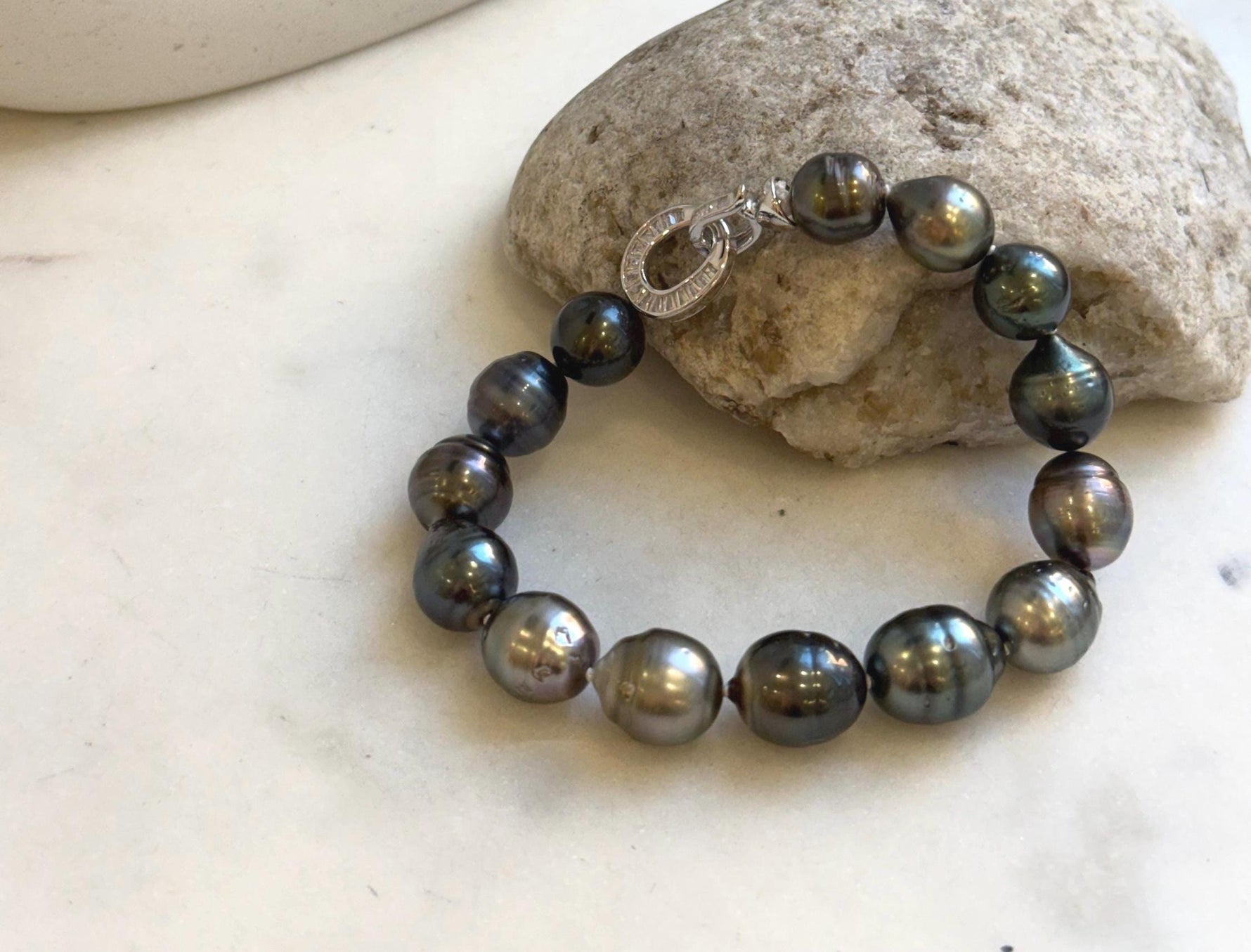 Elly’s 10.1-11.7mm 14pcs Tahitian Ocean peacock green huber Pearls Bracelet: Extreme luster, 8.1” knotted. Pearl jewelry idea.