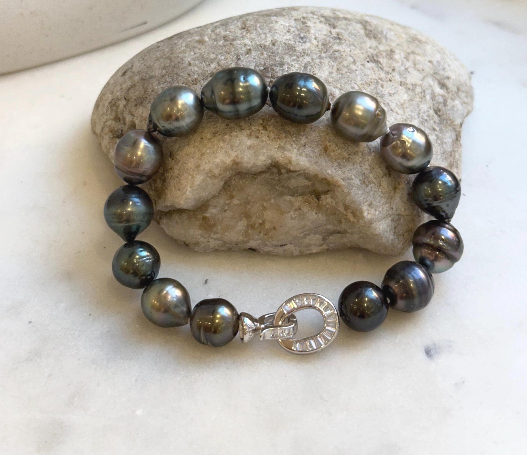 Elly’s 10.1-11.7mm 14pcs Tahitian Ocean peacock green huber Pearls Bracelet: Extreme luster, 8.1” knotted. Pearl jewelry idea.