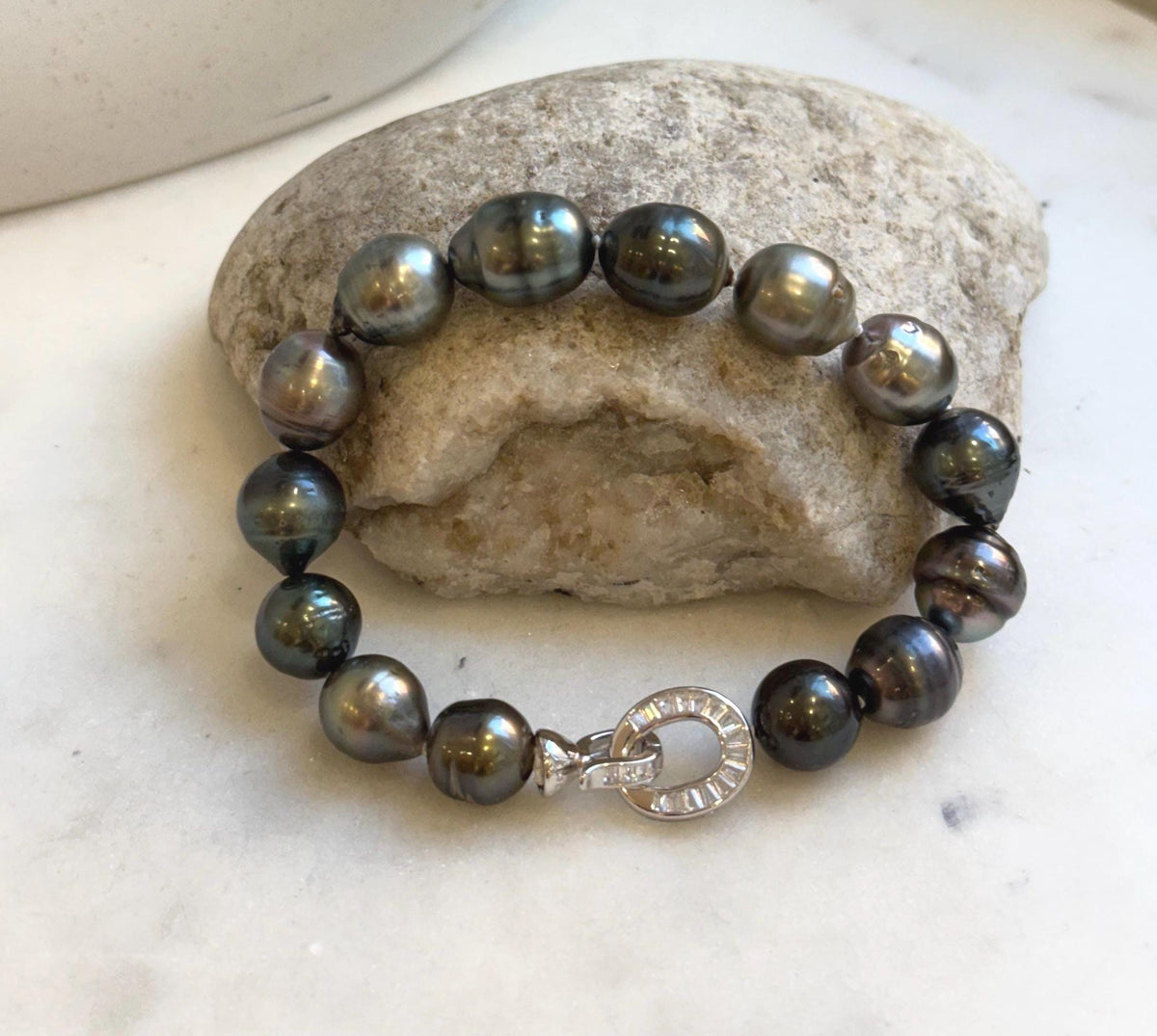 Elly’s 10.1-11.7mm 14pcs Tahitian Ocean peacock green huber Pearls Bracelet: Extreme luster, 8.1” knotted. Pearl jewelry idea.