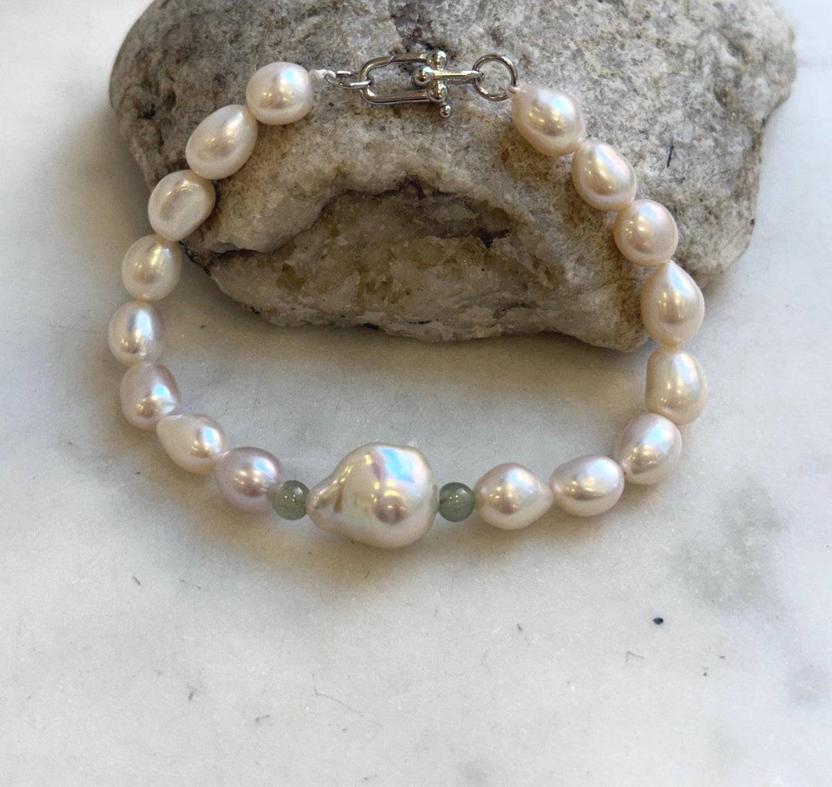 Elly’s 16pcs 7.1-13.1mm Baroque oval pearls Braclet: Extreme luster mirrored, 8”, S925 silver Braclet.