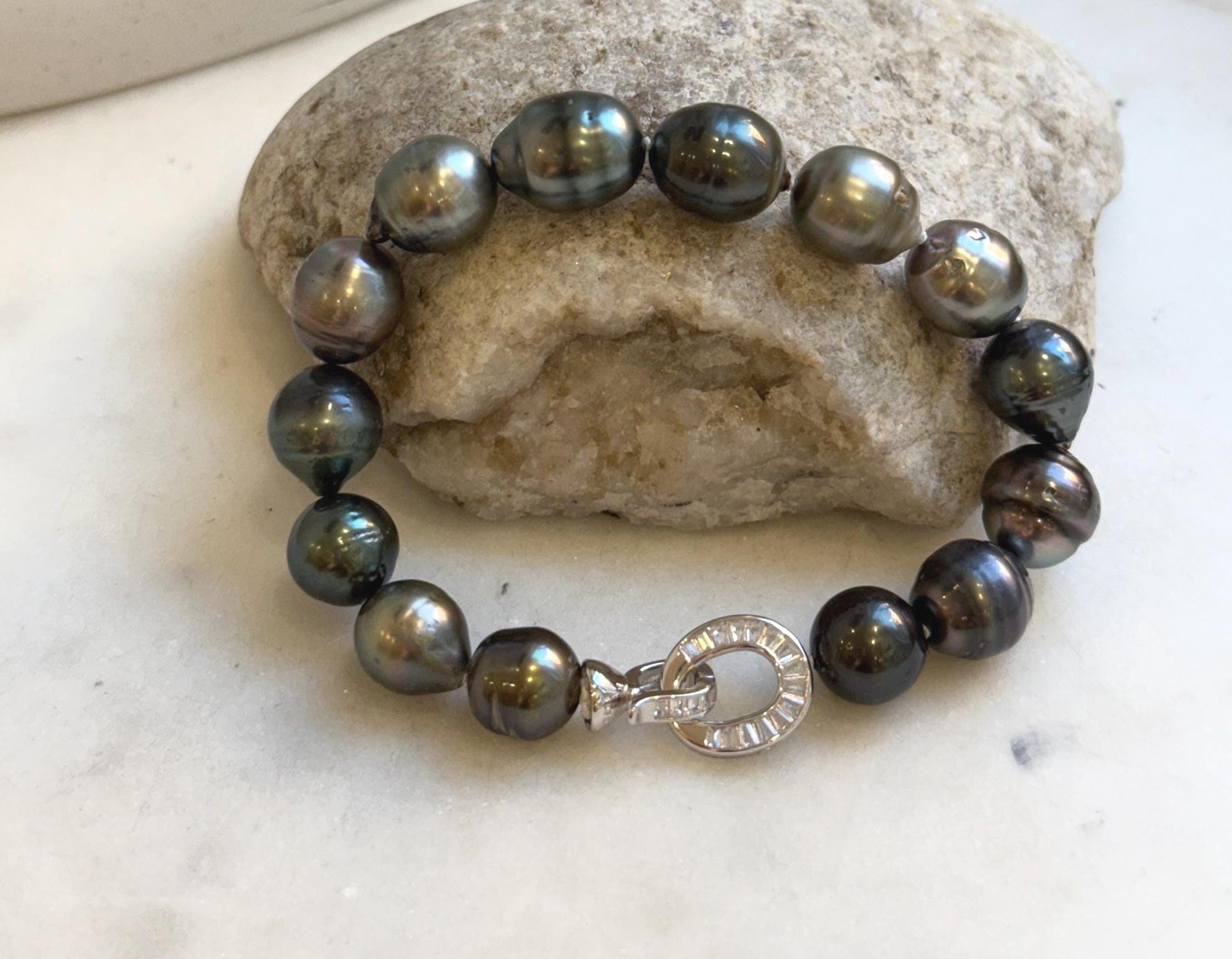Elly’s 10.1-11.7mm 14pcs Tahitian Ocean peacock green huber Pearls Bracelet: Extreme luster, 8.1” knotted. Pearl jewelry idea.