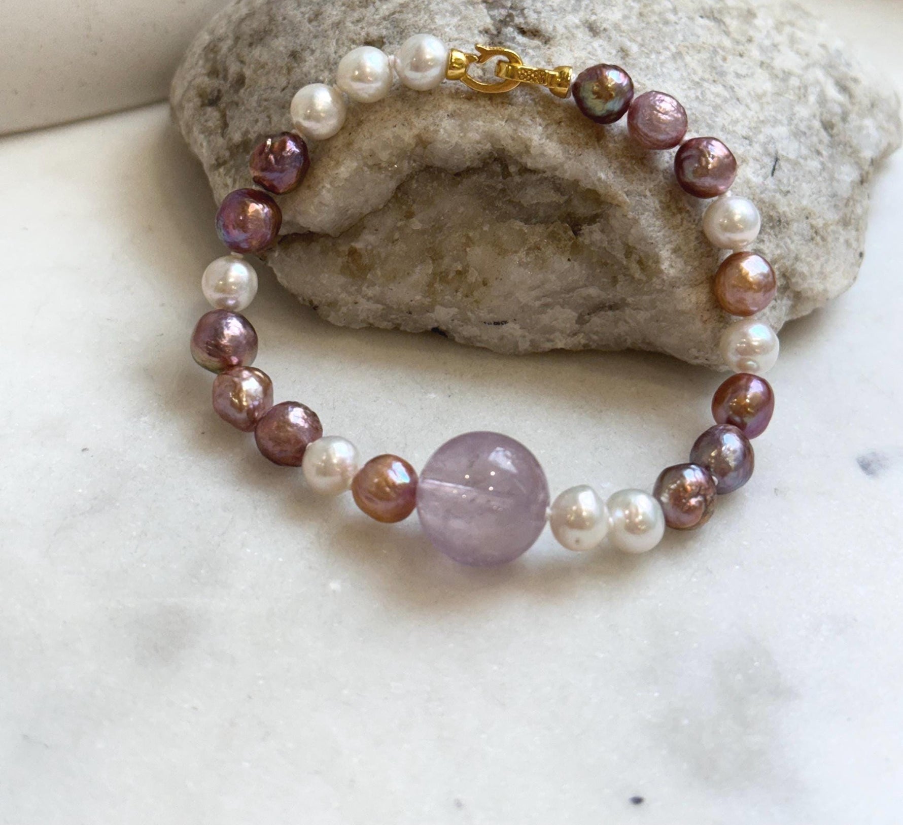 Elly’s 6.4-7.4mm Freshwater Pearls Bracelet: Extreme luster, 7.6” knotted, S925 silver clip bracelet with Amethyst.