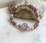 Elly’s 6.4-7.4mm Freshwater Pearls Bracelet: Extreme luster, 7.6” knotted, S925 silver clip bracelet with Amethyst.