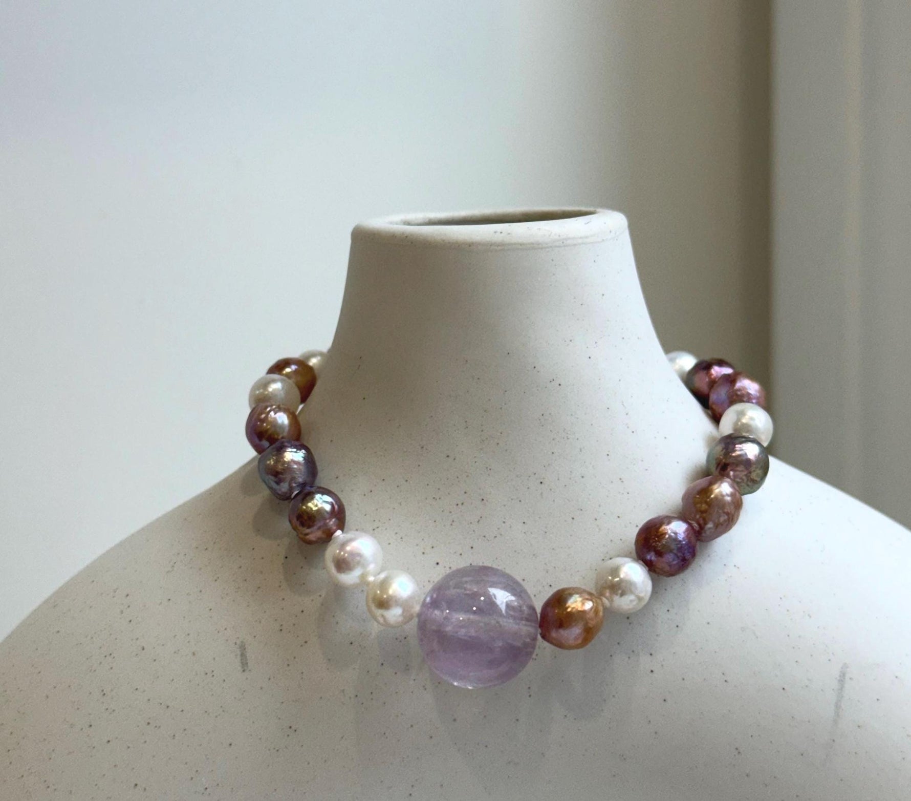 Elly’s 6.4-7.4mm Freshwater Pearls Bracelet: Extreme luster, 7.6” knotted, S925 silver clip bracelet with Amethyst.