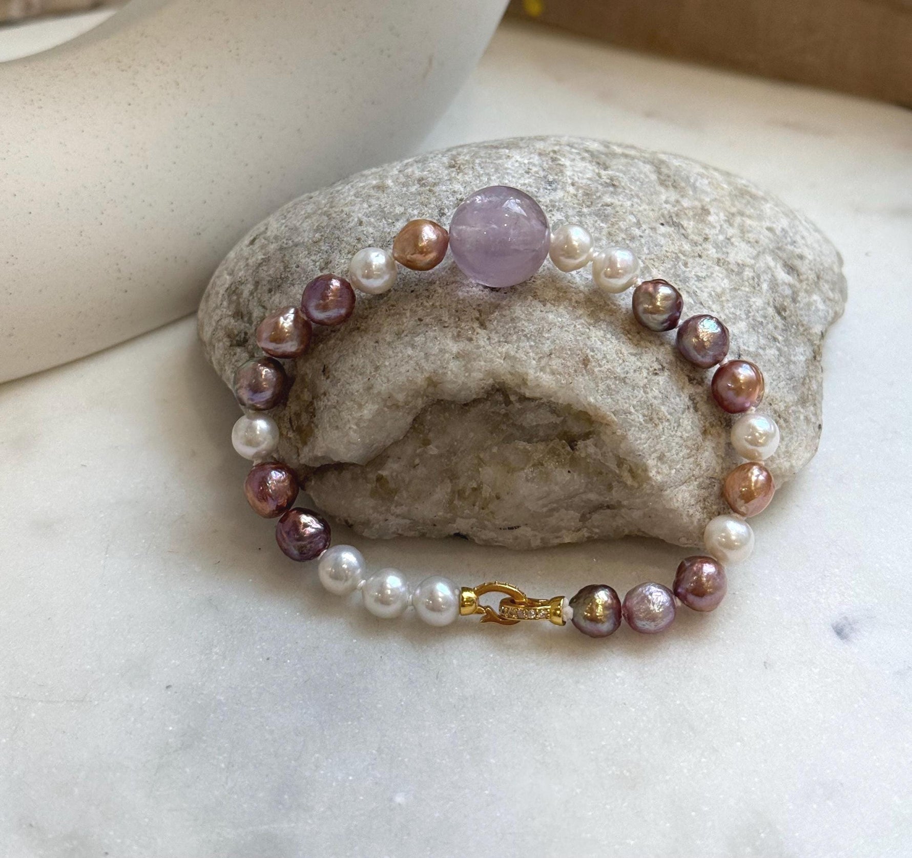 Elly’s 6.4-7.4mm Freshwater Pearls Bracelet: Extreme luster, 7.6” knotted, S925 silver clip bracelet with Amethyst.