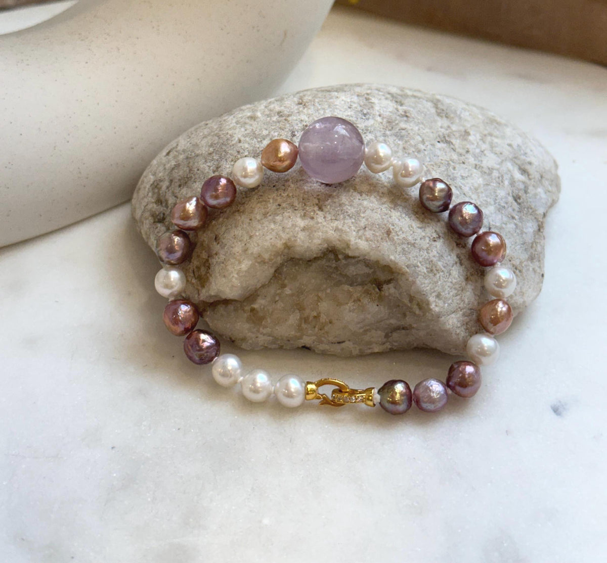 Elly’s 6.4-7.4mm Freshwater Pearls Bracelet: Extreme luster, 7.6” knotted, S925 silver clip bracelet with Amethyst.