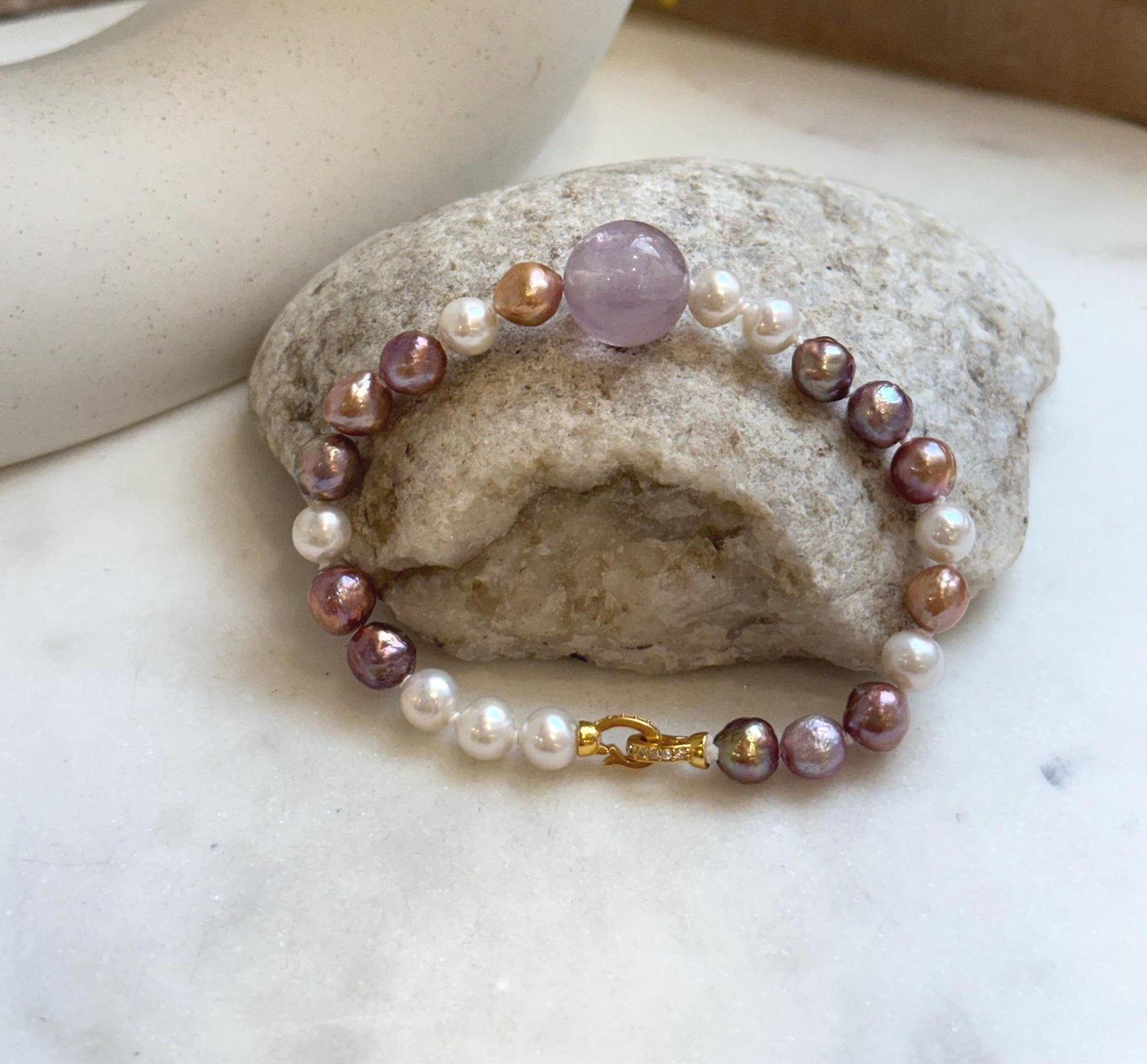 Elly’s 6.4-7.4mm Freshwater Pearls Bracelet: Extreme luster, 7.6” knotted, S925 silver clip bracelet with Amethyst.