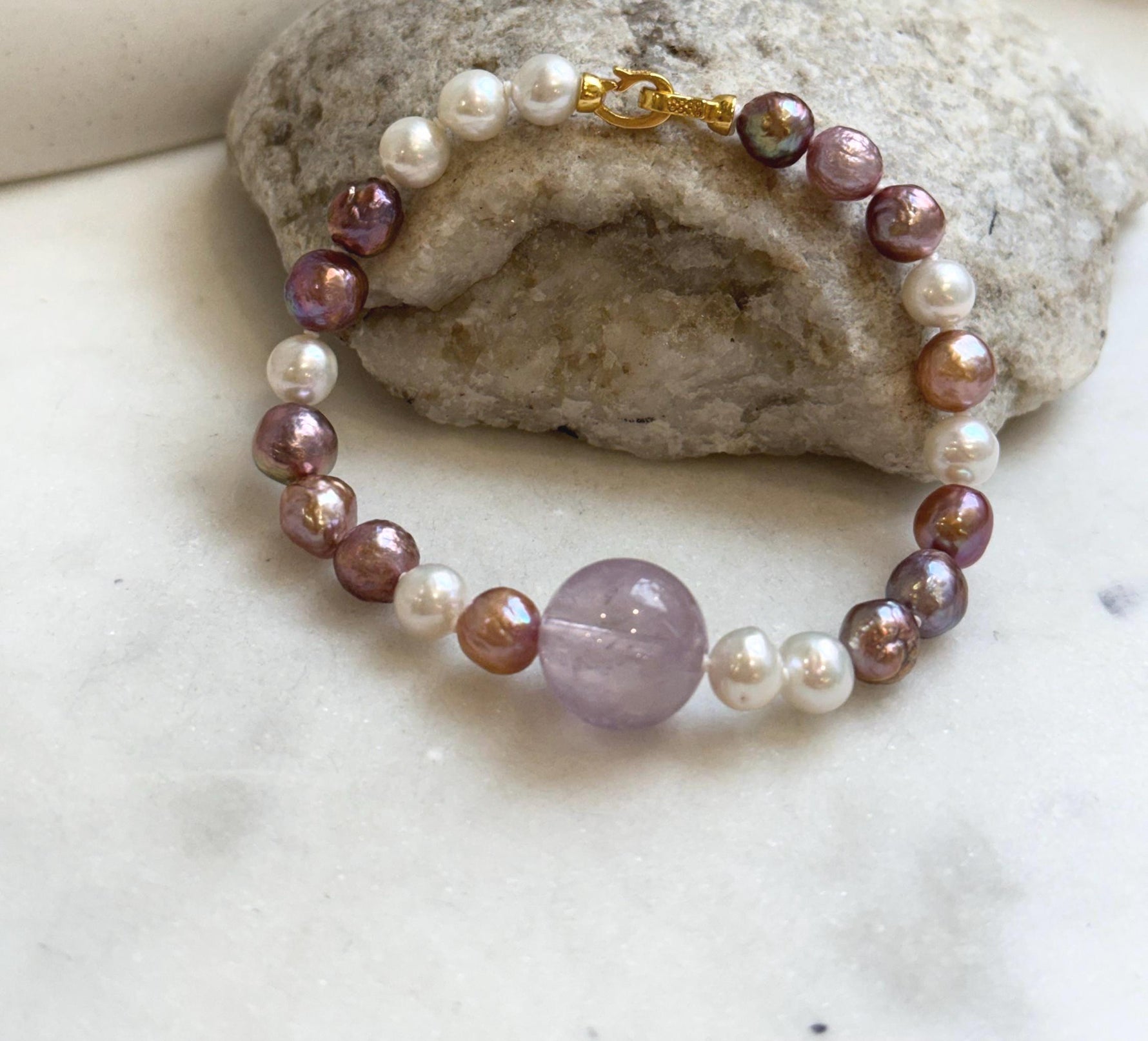 Elly’s 6.4-7.4mm Freshwater Pearls Bracelet: Extreme luster, 7.6” knotted, S925 silver clip bracelet with Amethyst.
