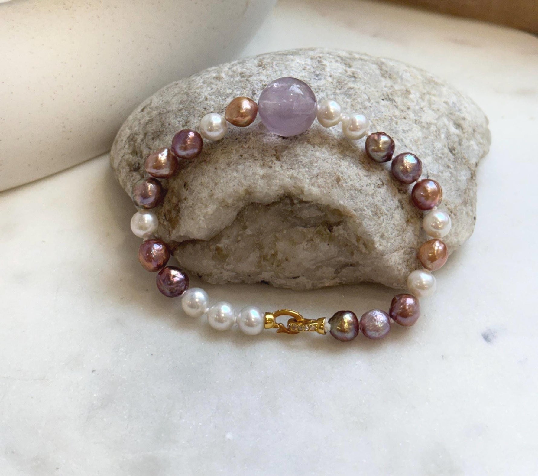 Elly’s 6.4-7.4mm Freshwater Pearls Bracelet: Extreme luster, 7.6” knotted, S925 silver clip bracelet with Amethyst.