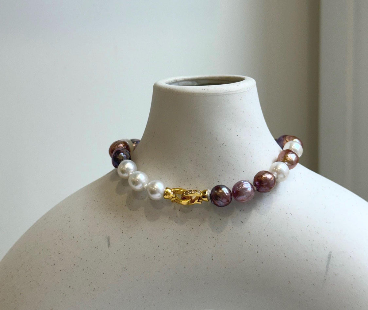 Elly’s 6.4-7.4mm Freshwater Pearls Bracelet: Extreme luster, 7.6” knotted, S925 silver clip bracelet with Amethyst.