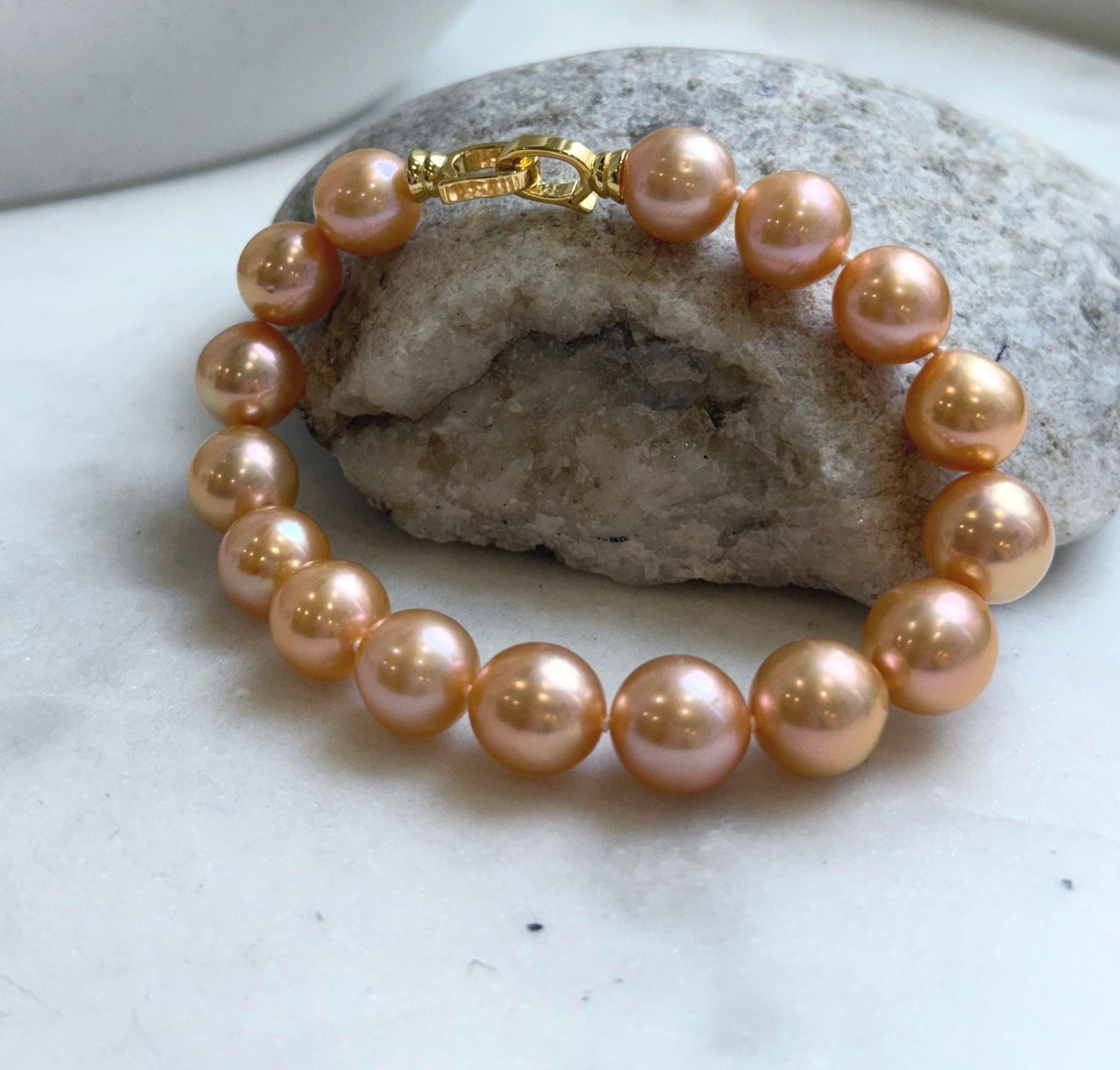 Elly’s 16pcs 9.8-11mm Natural Sunset Peach Gold Edison Pearls Bracelet: Extreme luster mirrored, 8” knotted, S925 silver Bracelet.
