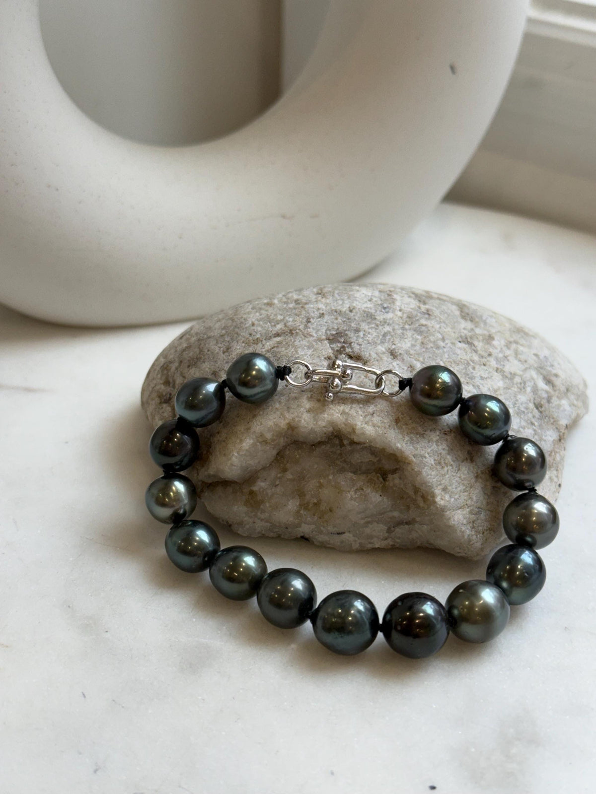 Elly’s 9.8-11.5mm 15pcs Tahitian Ocean peacock black hunter Pearls Bracelet: Extreme luster mirrored, 8.1” knotted. Pearl jewelry idea.