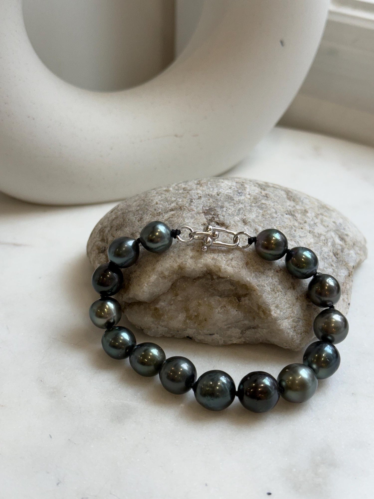 Elly’s 9.8-11.5mm 15pcs Tahitian Ocean peacock black hunter Pearls Bracelet: Extreme luster mirrored, 8.1” knotted. Pearl jewelry idea.