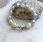 Elly’s 12pcs Australian Ocean white silver Pearls Bracelet: Extreme luster mirrored, to 18.2mm, 8.4” knotted, S925 silver clip.