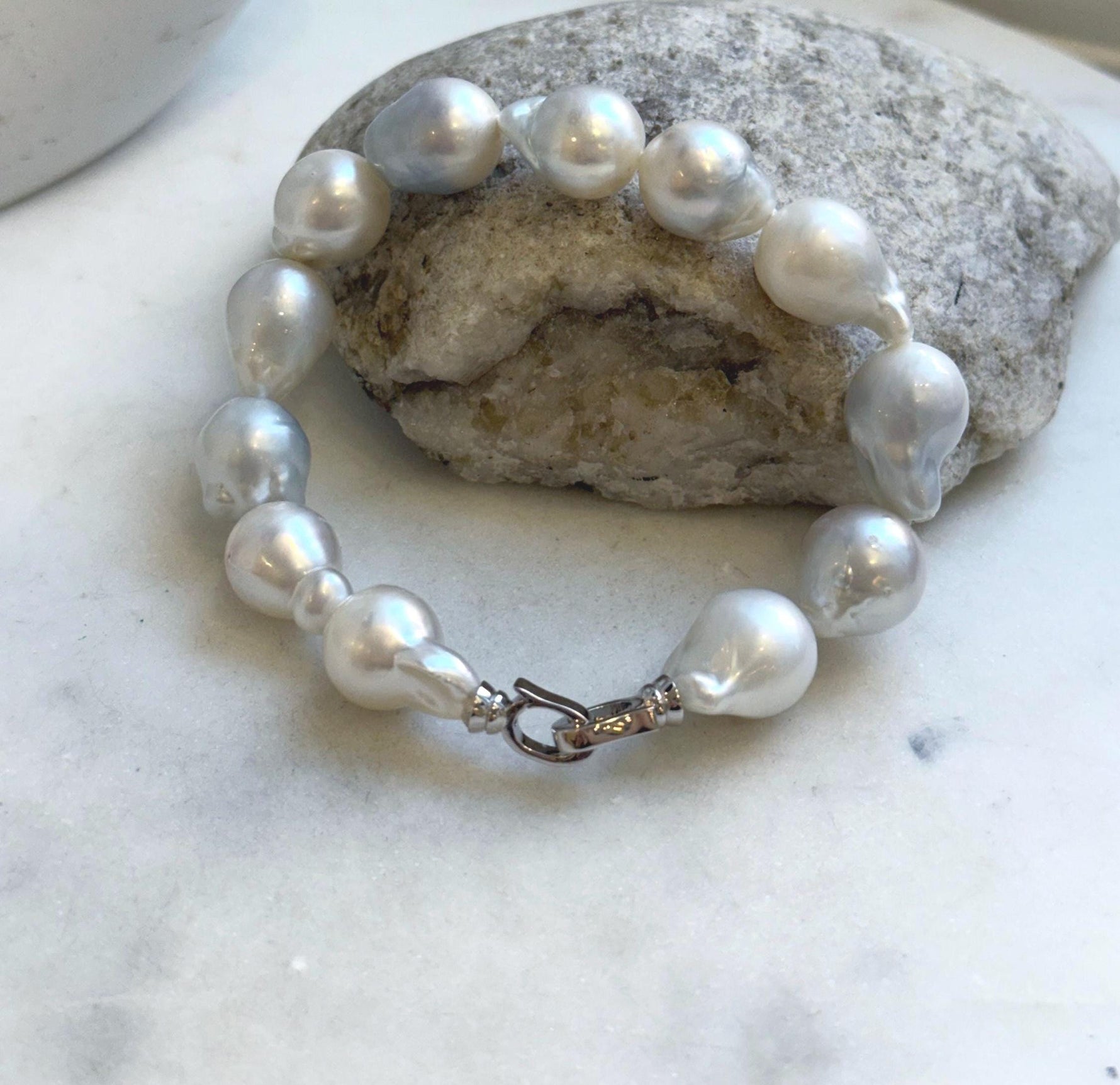 Elly’s 12pcs Australian Ocean white silver Pearls Bracelet: Extreme luster mirrored, to 18.2mm, 8.4” knotted, S925 silver clip.