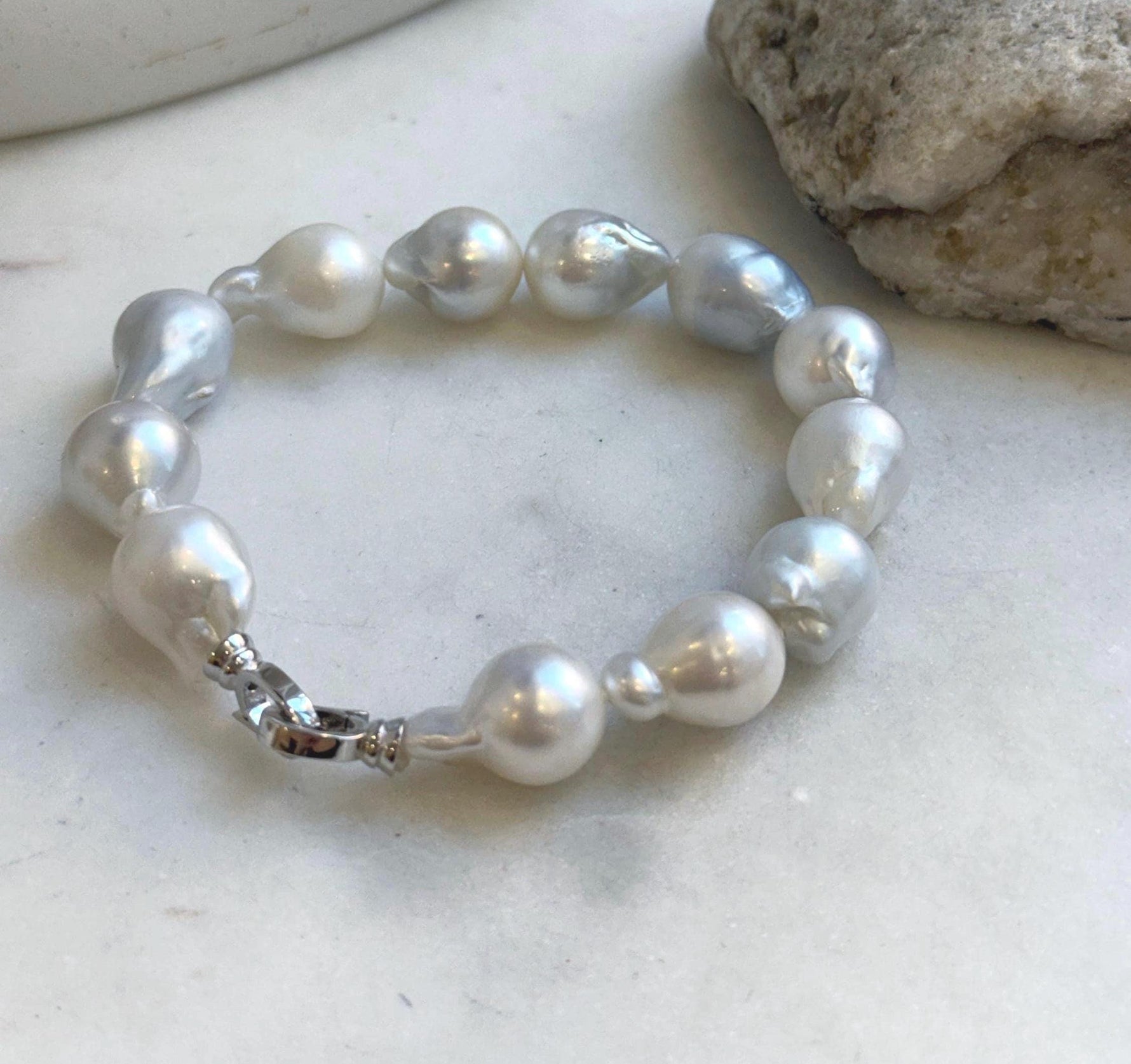 Elly’s 12pcs Australian Ocean white silver Pearls Bracelet: Extreme luster mirrored, to 18.2mm, 8.4” knotted, S925 silver clip. good for her birthdays gift