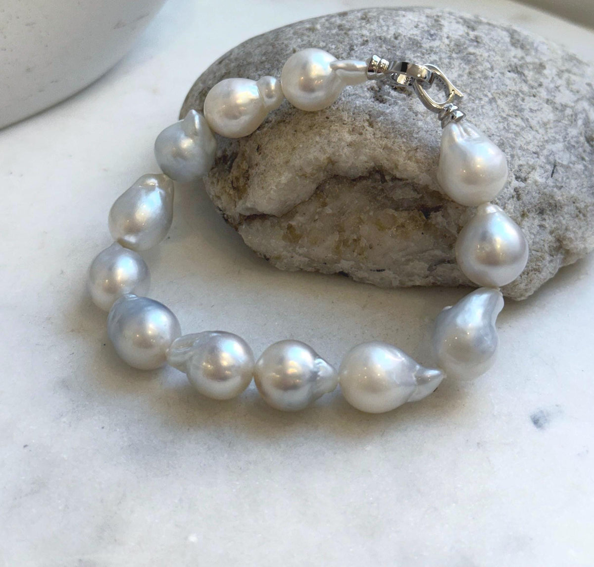 Elly’s 12pcs Australian Ocean white silver Pearls Bracelet: Extreme luster mirrored, to 18.2mm, 8.4” knotted, S925 silver clip.