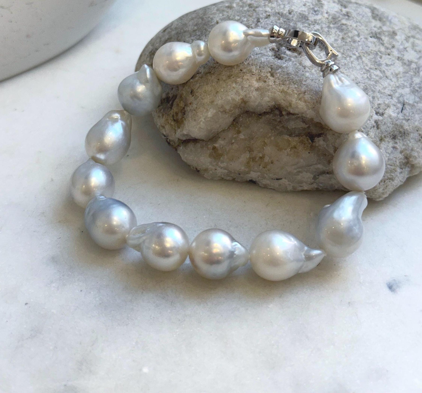 Elly’s 12pcs Australian Ocean white silver Pearls Bracelet: Extreme luster mirrored, to 18.2mm, 8.4” knotted, S925 silver clip.