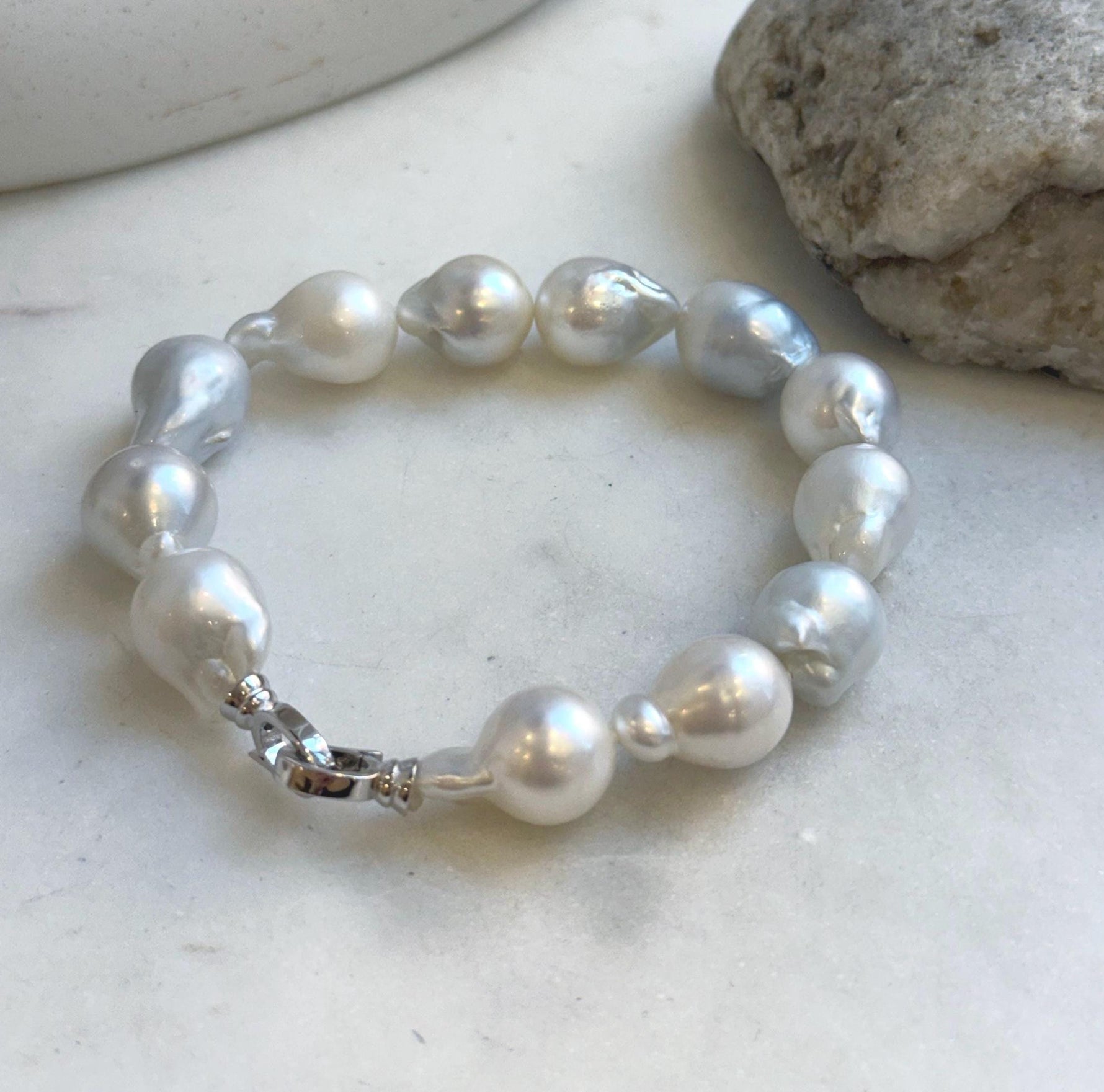 Elly’s 12pcs Australian Ocean white silver Pearls Bracelet: Extreme luster mirrored, to 18.2mm, 8.4” knotted, S925 silver clip.