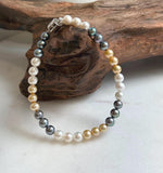 Elly’s 5.2-5.5mm  Freshwater White golden peacock pearls bracelet: Extreme luster mirrored, s925 silver bracelet, different sizes.