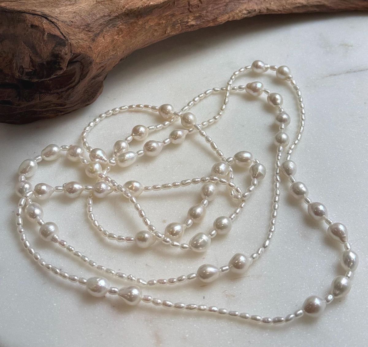 Elly’s 2.5-7.5mm Freshwater white iridescent Keshi pearls Long necklace:Extreme luster mirrored.