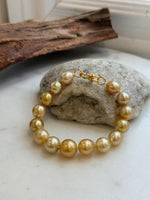 Elly’s 9.8-12.5mm 15pcs Genius South sea golden Ocean Pearls bracelet: Extreme luster, 8.1”, S925 silver bracelet.