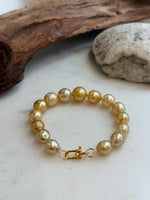Elly’s 9.8-12.5mm 15pcs Genius South sea golden Ocean Pearls bracelet: Extreme luster, 8.1”, S925 silver bracelet.