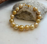 Elly’s 9.8-12.5mm 15pcs Genius South sea golden Ocean Pearls bracelet: Extreme luster, 8.1”, S925 silver bracelet.