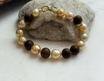 Elly’s 11pcs Genius South Sea Golden ocean Pearls Agarwood bracelet: Extreme luster, 8.9-10.5mm, 8.2” knotted.