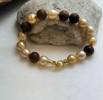 Elly’s 11pcs Genius South Sea Golden ocean Pearls Agarwood bracelet: Extreme luster, 8.9-10.5mm, 8.2” knotted.