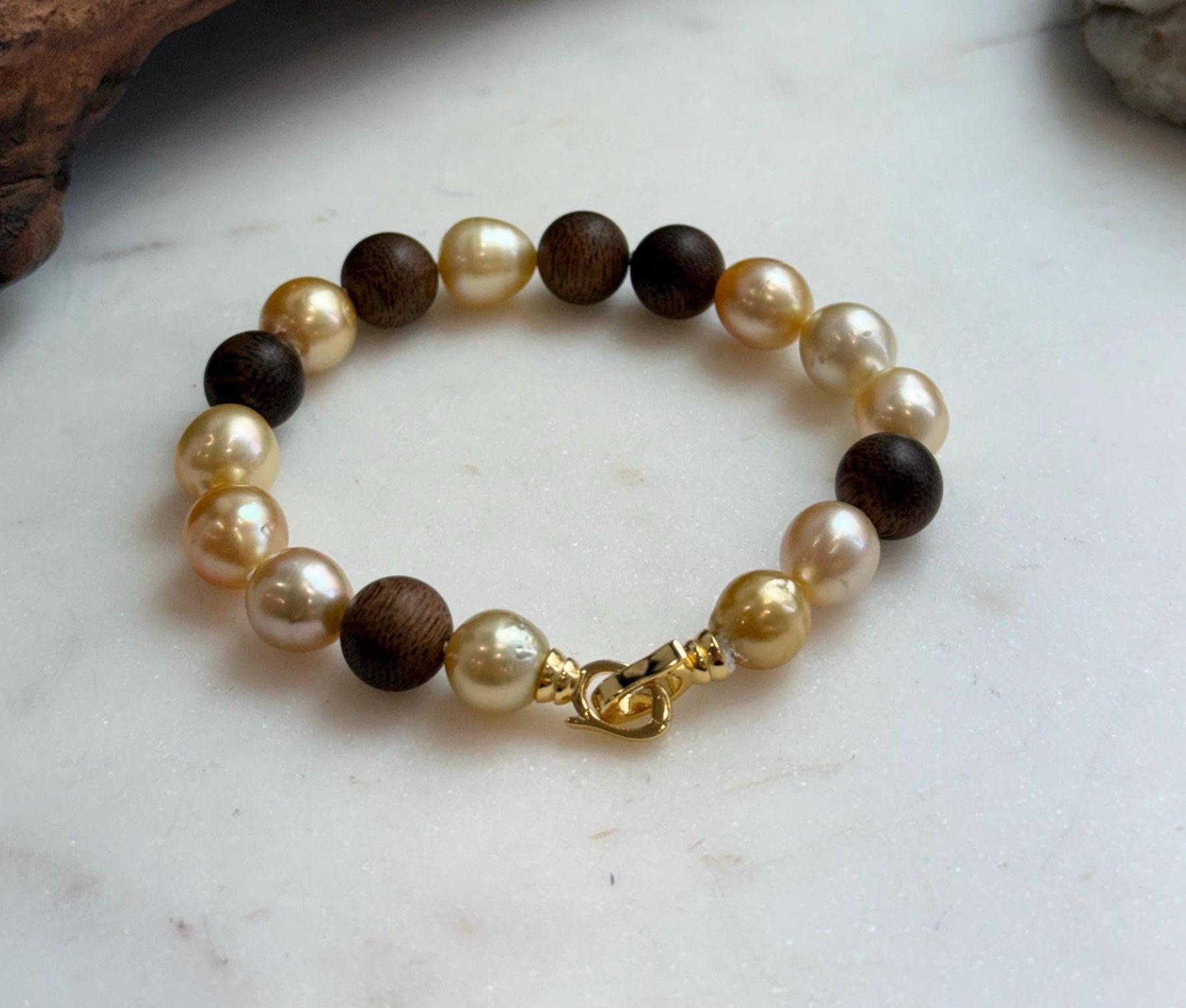Elly’s 11pcs Genius South Sea Golden ocean Pearls Agarwood bracelet: Extreme luster, 8.9-10.5mm, 8.2” knotted.