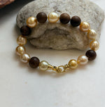 Elly’s 11pcs Genius South Sea Golden ocean Pearls Agarwood bracelet: Extreme luster, 8.9-10.5mm, 8.2” knotted.