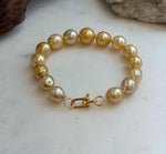 Elly’s 9.8-12.5mm 15pcs Genius South sea golden Ocean Pearls bracelet: Extreme luster, 8.1”, S925 silver bracelet.