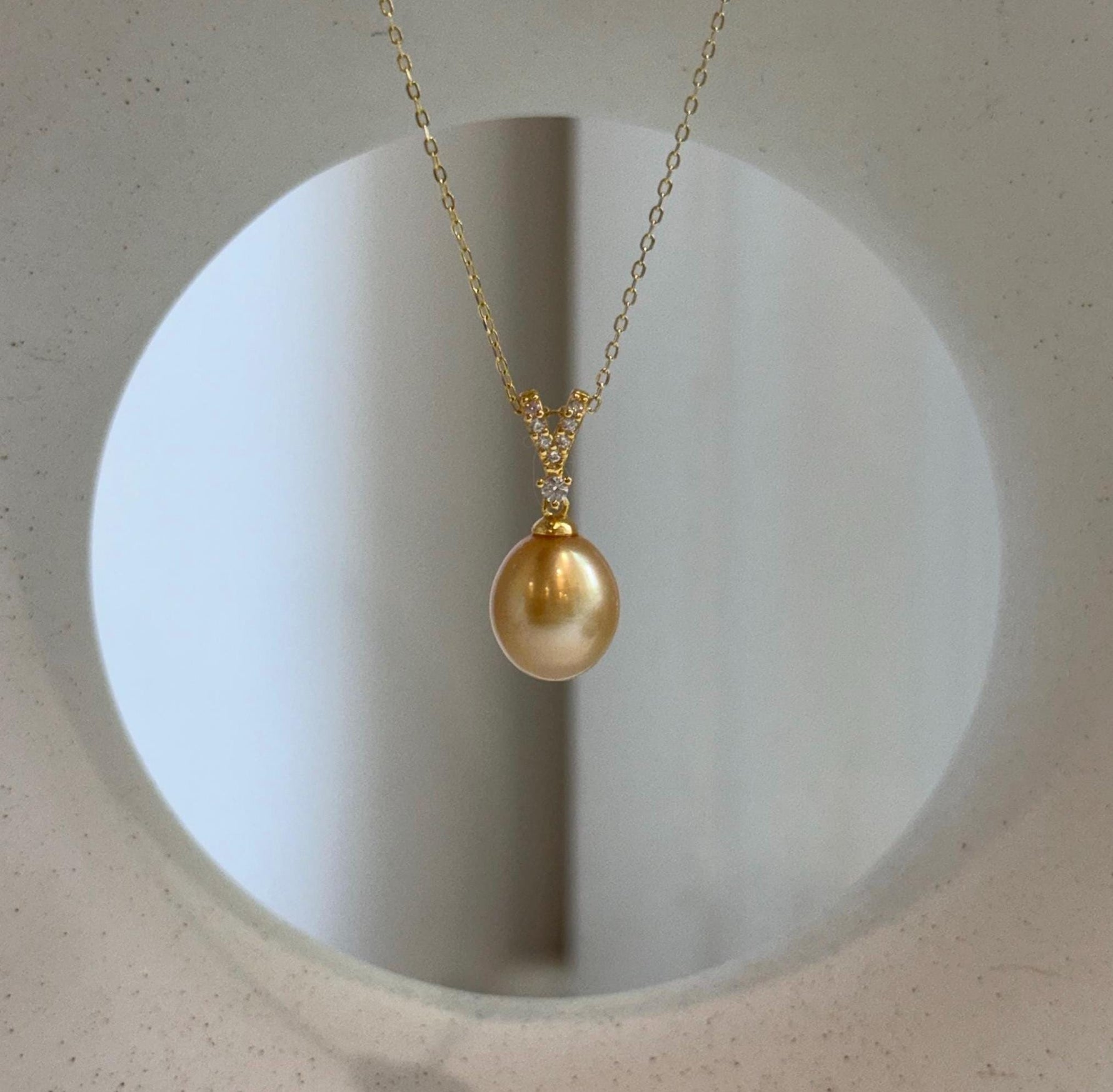 Elly’s 10mm South Sea deep Gold iridescent ocean Pearl pendant: Extreme luster mirrored, 2.2cm high, S925 silver w/ gold plated pendant.