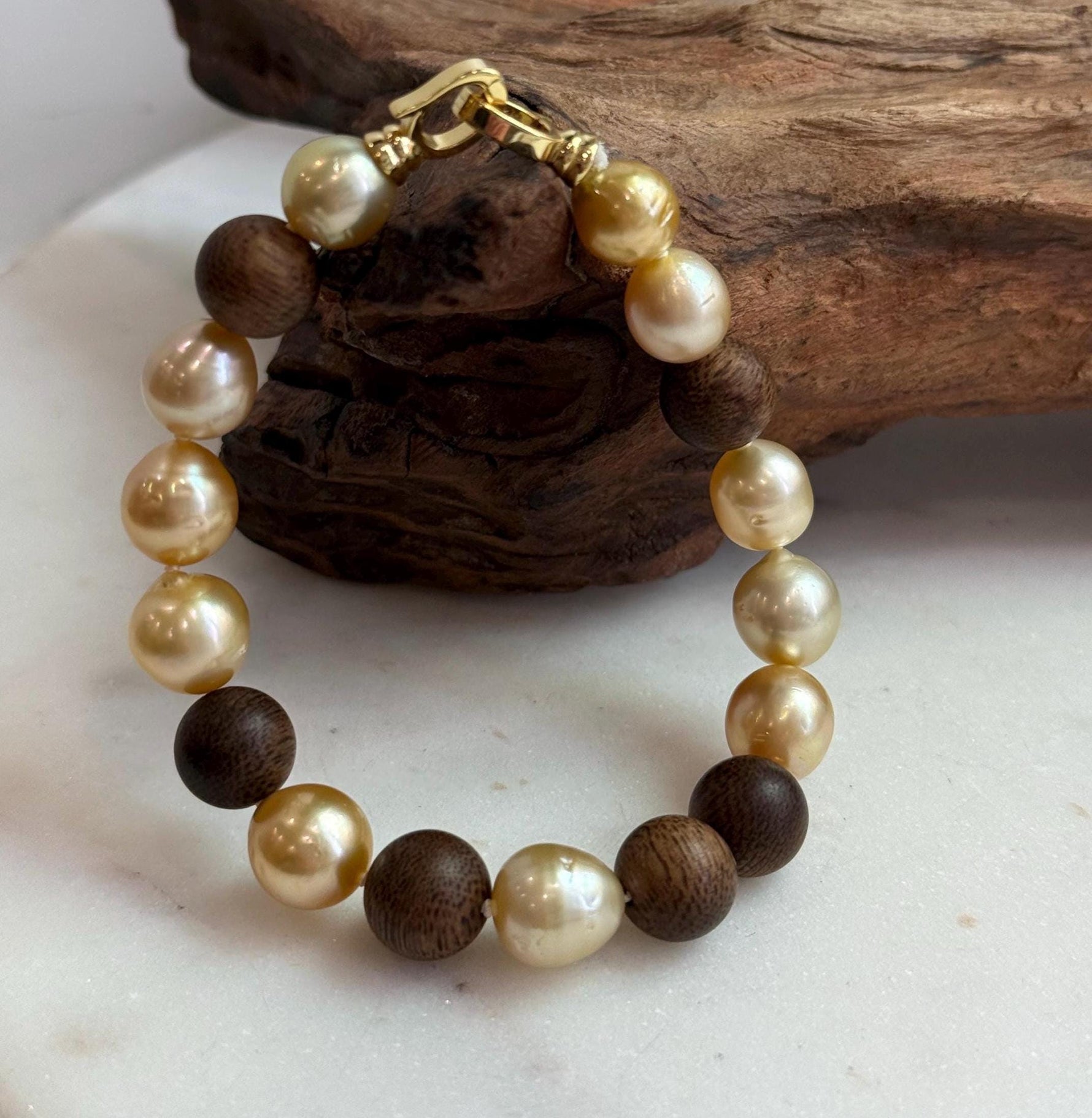 Elly’s 11pcs Genius South Sea Golden ocean Pearls Agarwood bracelet: Extreme luster, 8.9-10.5mm, 8.2” knotted.