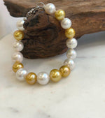 Elly’s 17pcs 10.2-11.5mm White golden Edison Pearls Bracelet: Extreme luster mirrored, 8.3” knotted, S925 silver Bracelet.