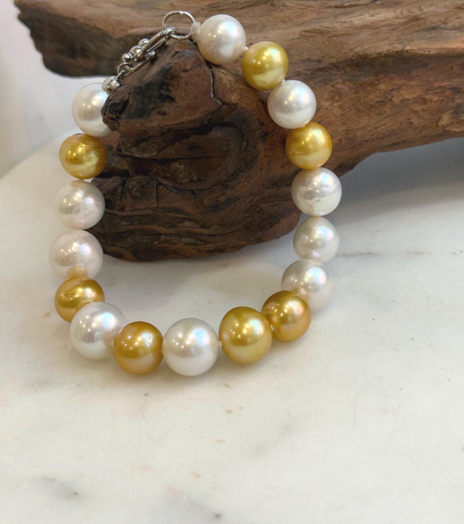 Elly’s 17pcs 10.2-11.5mm White golden Edison Pearls Bracelet: Extreme luster mirrored, 8.3” knotted, S925 silver Bracelet.