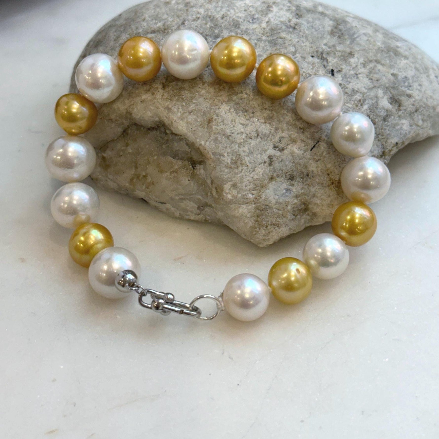 Elly’s 17pcs 10.2-11.5mm White golden Edison Pearls Bracelet: Extreme luster mirrored, 8.3” knotted, S925 silver Bracelet.