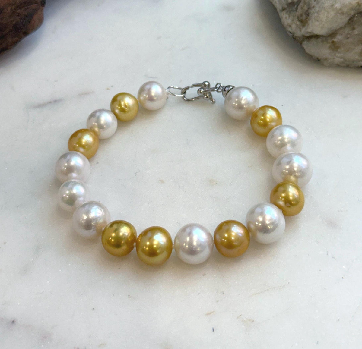 Elly’s 17pcs 10.2-11.5mm White golden Edison Pearls Bracelet: Extreme luster mirrored, 8.3” knotted, S925 silver Bracelet.
