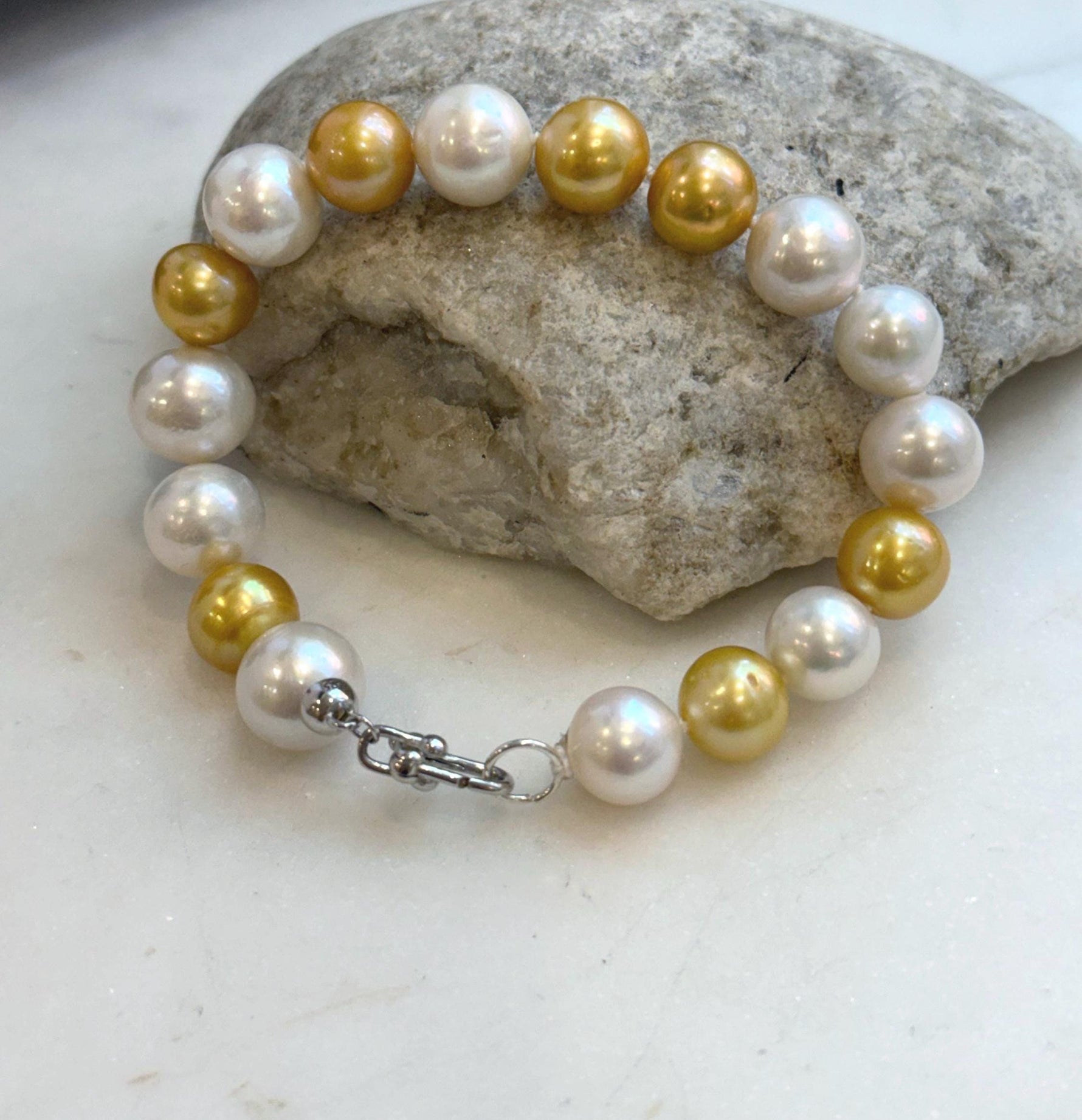 Elly’s 17pcs 10.2-11.5mm White golden Edison Pearls Bracelet: Extreme luster mirrored, 8.3” knotted, S925 silver Bracelet.