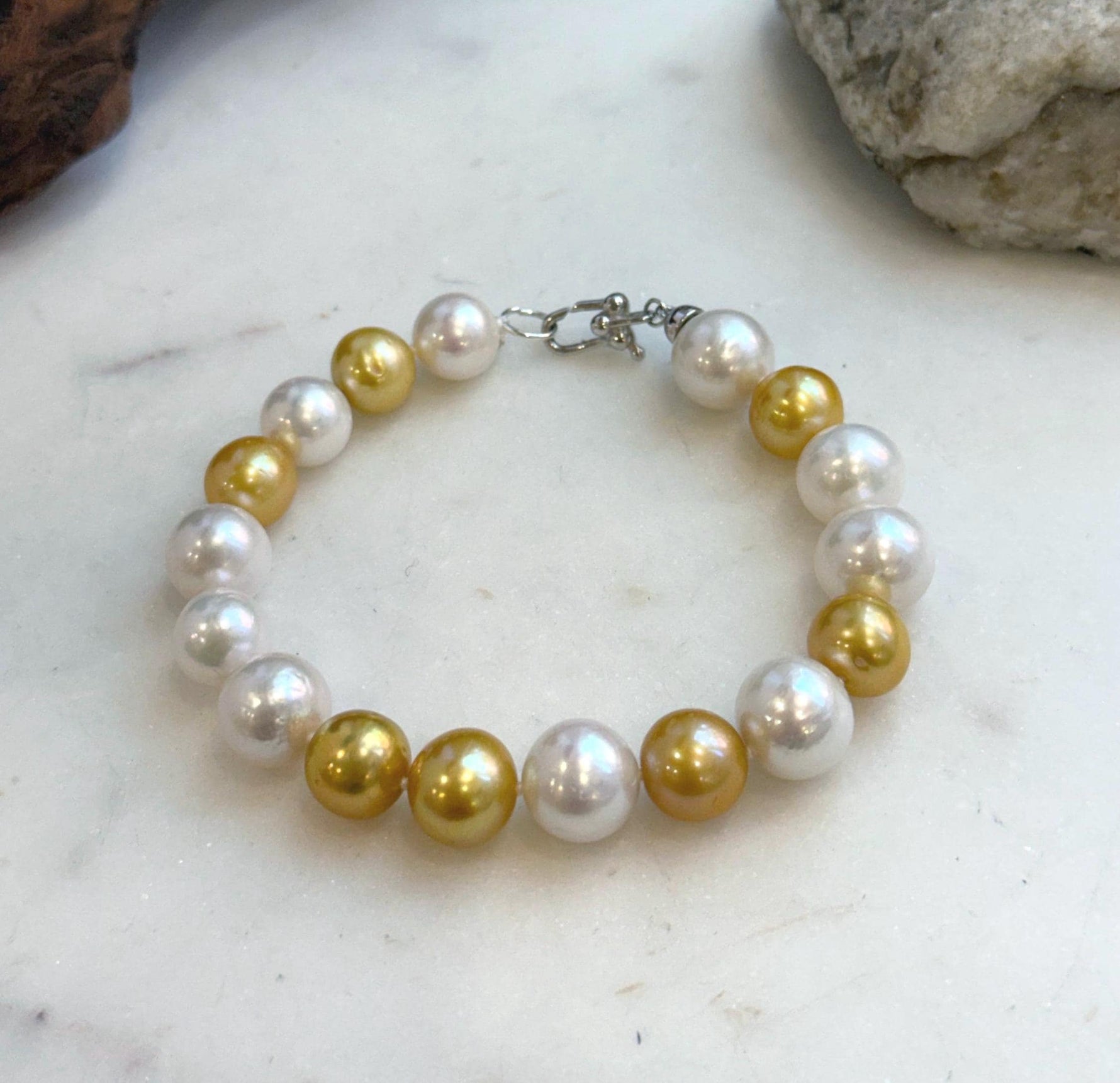 Elly’s 17pcs 10.2-11.5mm White golden Edison Pearls Bracelet: Extreme luster mirrored, 8.3” knotted, S925 silver Bracelet.