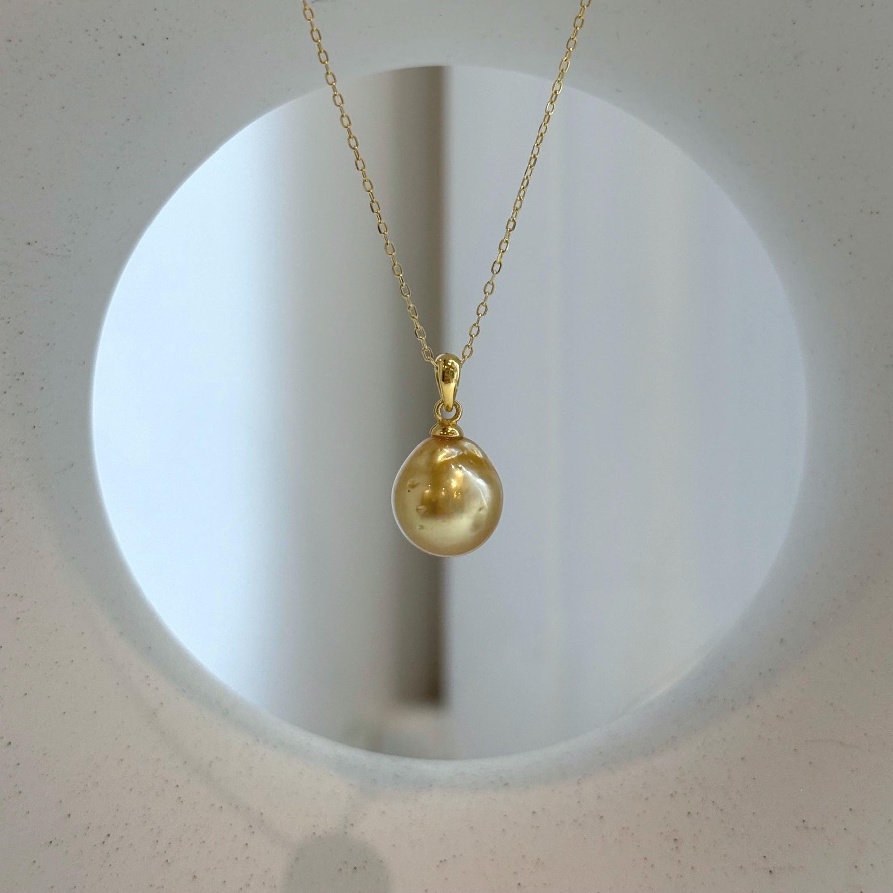 Elly’s 10.8mm South Sea deep tea Gold ocean Pearl pendant: Extreme luster mirrored, 1.9cm high, S925 silver w/ gold plated pendant.