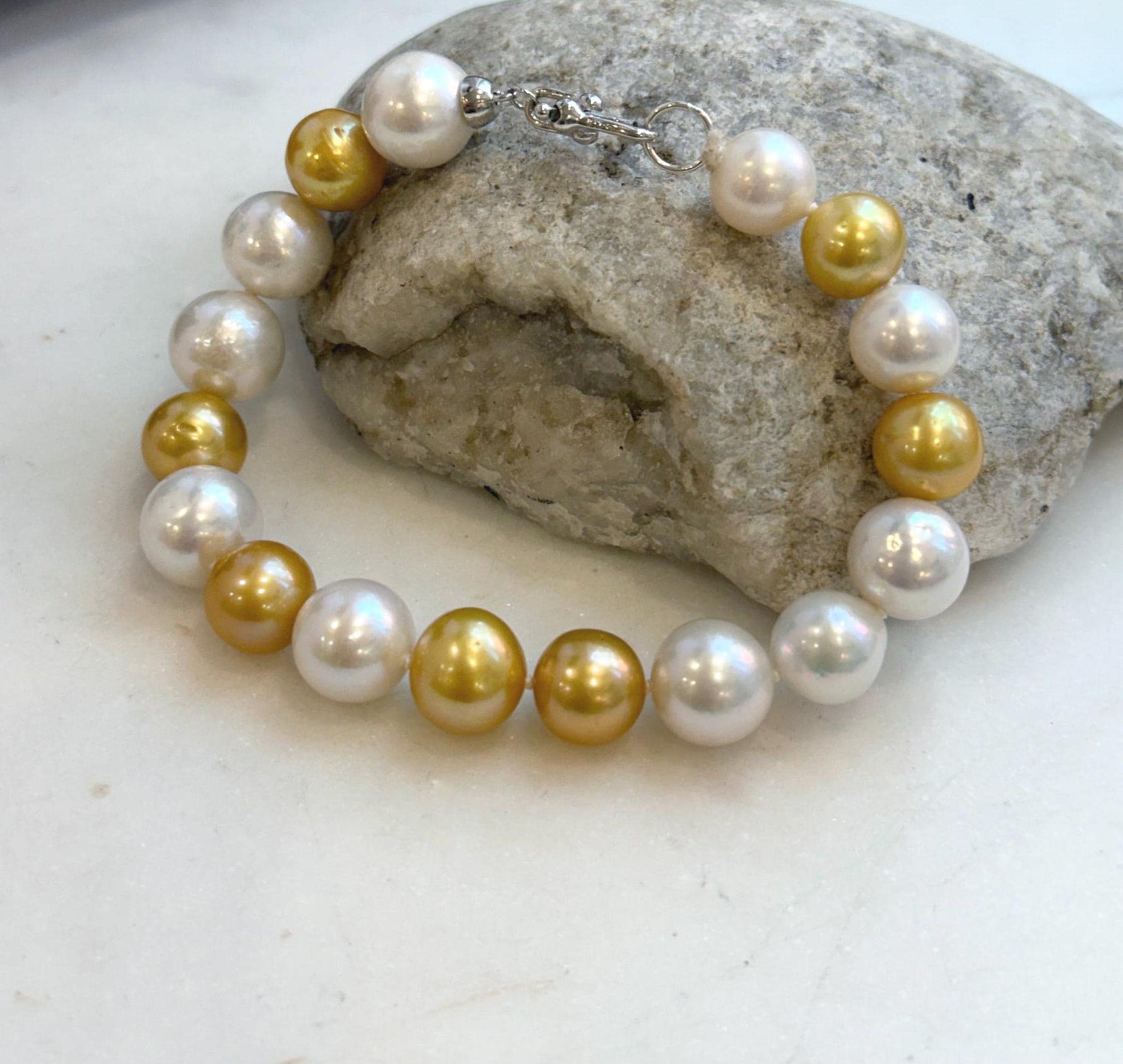 Elly’s 17pcs 10.2-11.5mm White golden Edison Pearls Bracelet: Extreme luster mirrored, 8.3” knotted, S925 silver Bracelet.